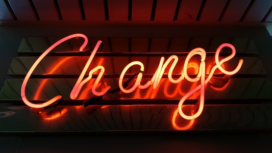 neon logo saying change